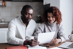 Retired couple reviewing their Social Security COLA increase letter at home
