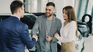 Older couple completing a car purchase at a dealership