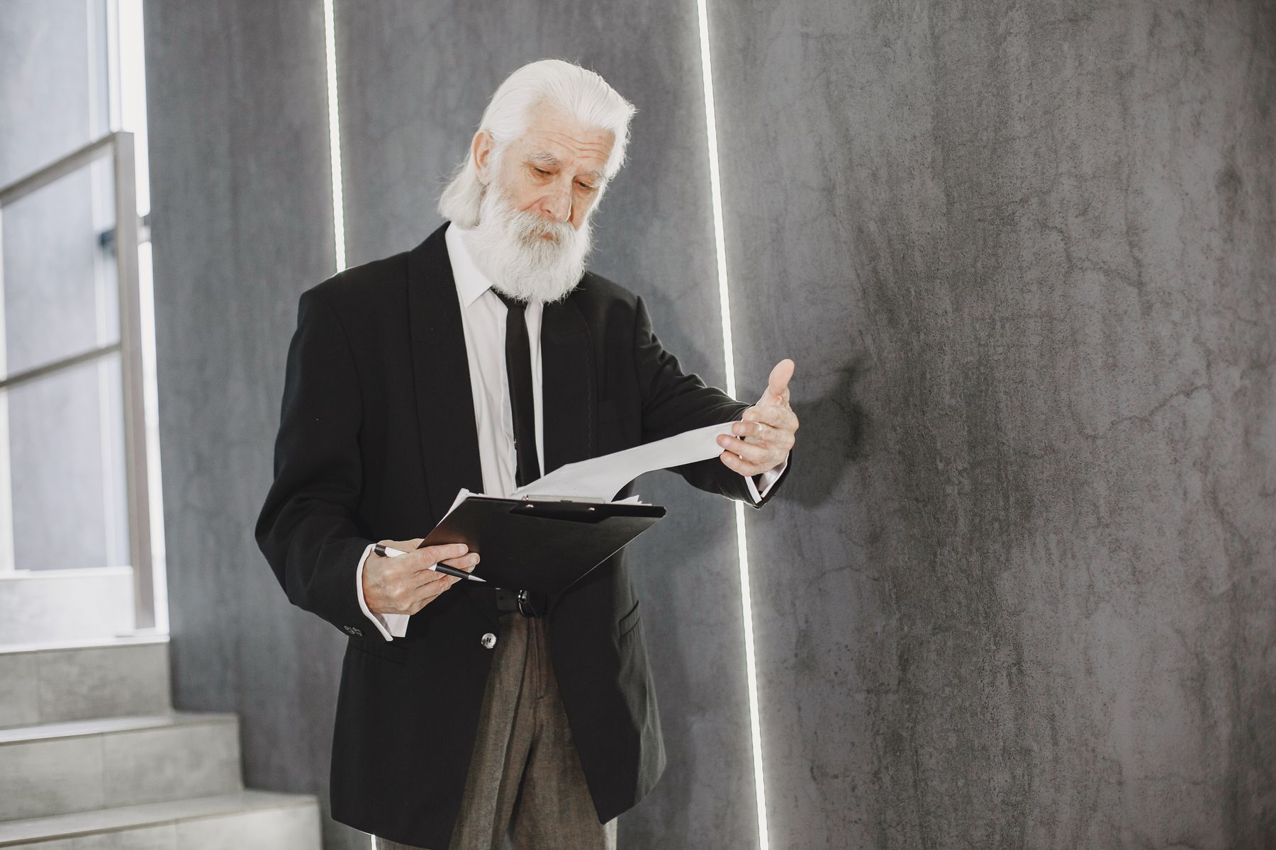 Retiree reviewing CPP Post-Retirement Benefit paperwork while working part-time