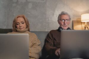 Retired couple reviewing retirement withdrawal plans on a laptop at home