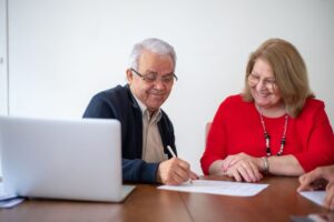 Couple age 55 and older reviewing 2026 HSA contribution limits on a laptop