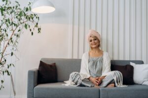 Senior woman wearing a medical alert pendant at home