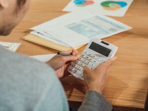 Calculator and medical receipts on a desk representing tax deduction calculations