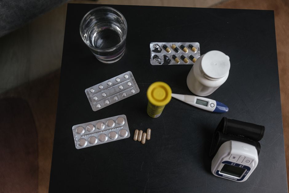Several prescription medication bottles arranged on a kitchen table