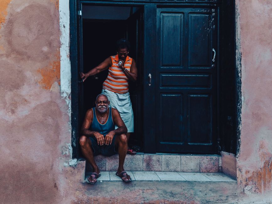 senior couple receiving a grocery delivery box at their front door