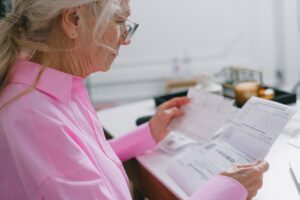 Surviving spouse reviewing tax documents at home