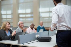 older adult student taking notes in a college classroom