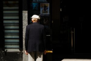 senior couple purchasing discounted movie tickets at theater box office