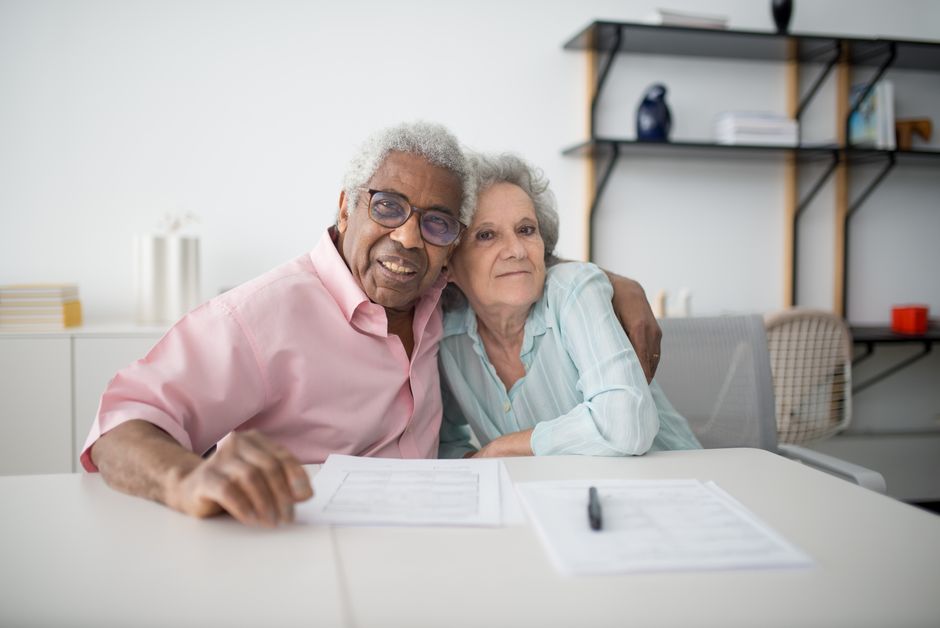Senior couple reviewing a property tax bill and paperwork at their kitchen table