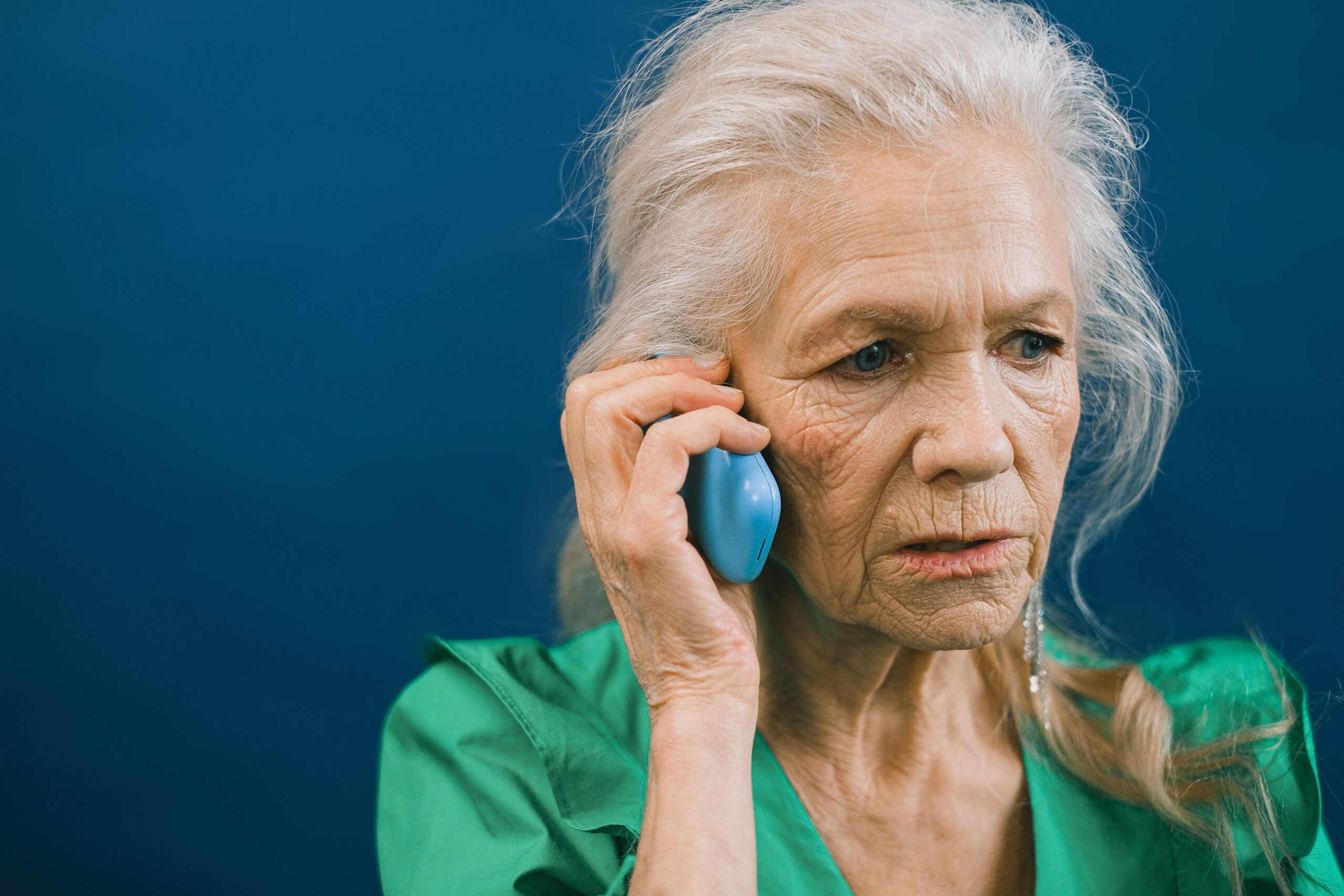 Senior on the phone negotiating a hospital bill with the billing office