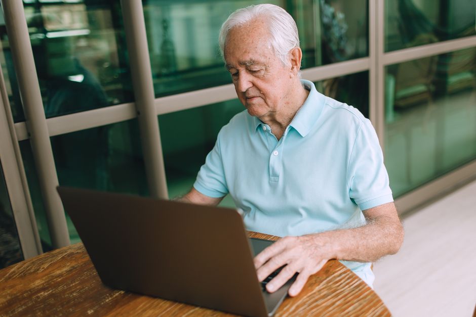 Senior renter reviewing HUD Section 8 housing voucher information on a laptop