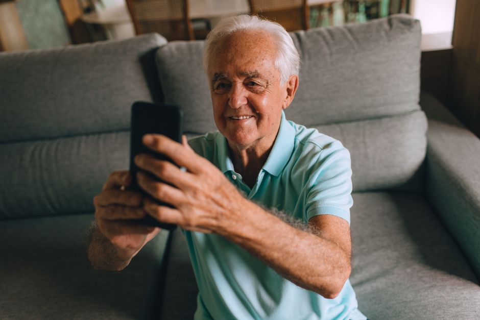 Senior scheduling a ride using a transportation app on a smartphone