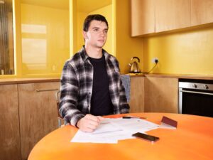 person reviewing medical paperwork and disability benefit documents at home