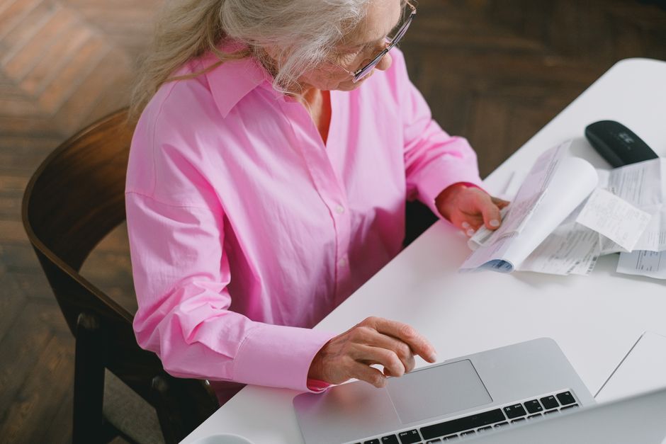 Widow reviewing Social Security survivor benefit paperwork at home