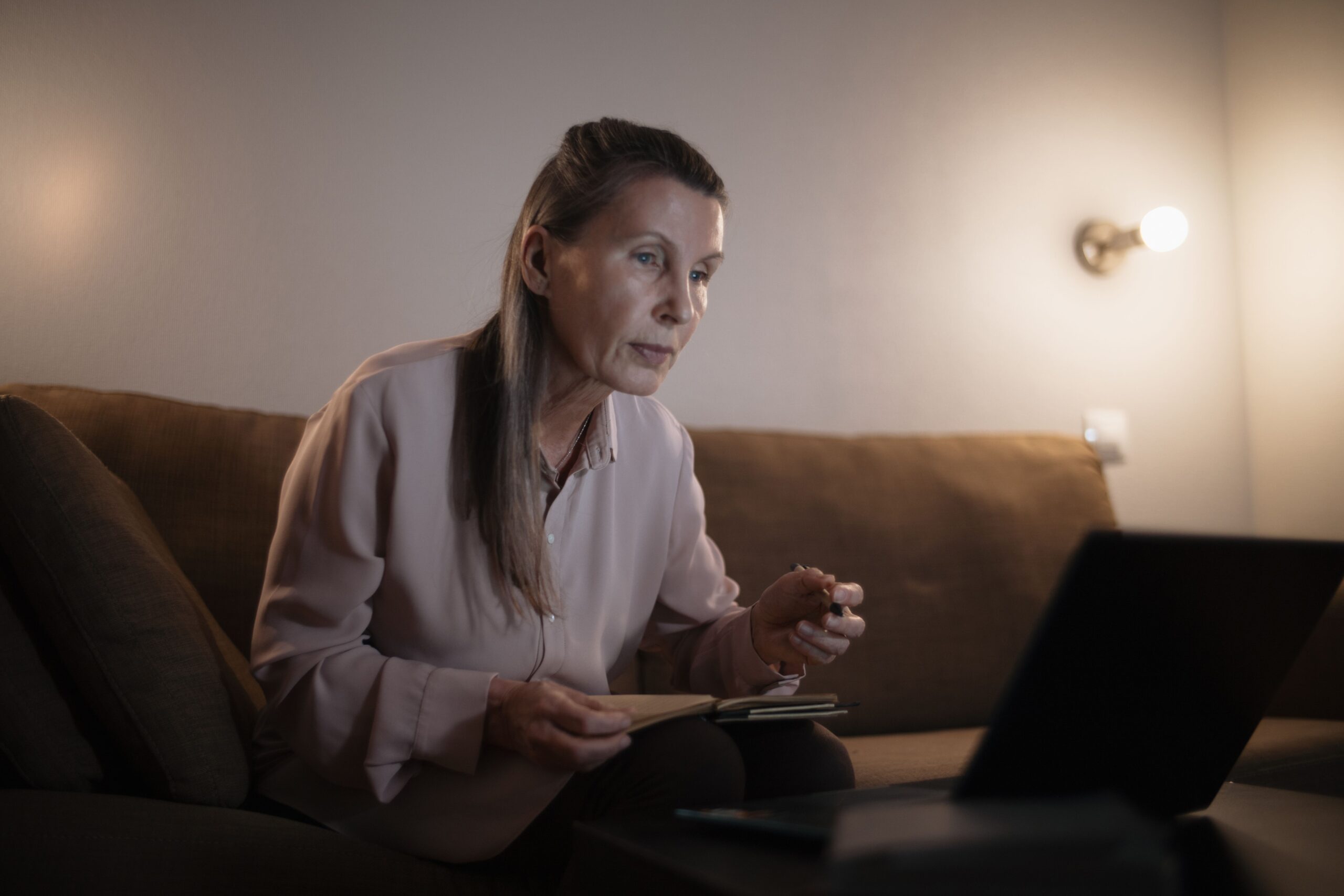 Senior searching for state utility assistance programs on a laptop