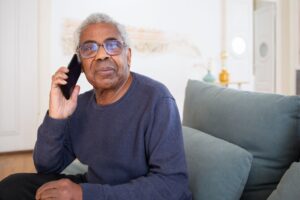 Senior reviewing a utility bill while on the phone with their provider