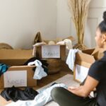 Retiree sorting through a box of clothes and household items to sell