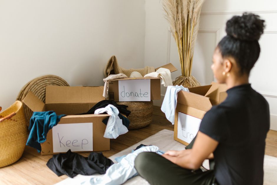 Retiree sorting through a box of clothes and household items to sell