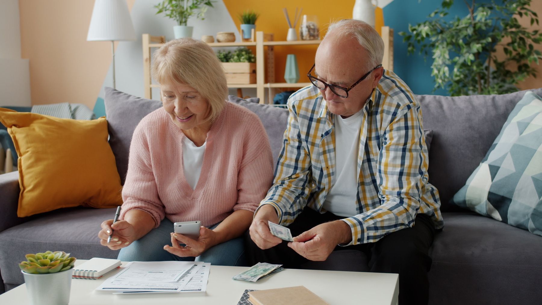 Retired couple reviewing household budget together at home
