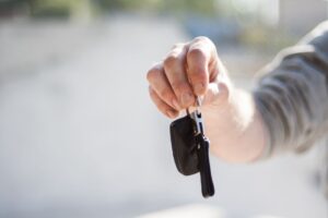 Senior couple picking up a rental car at an airport rental counter