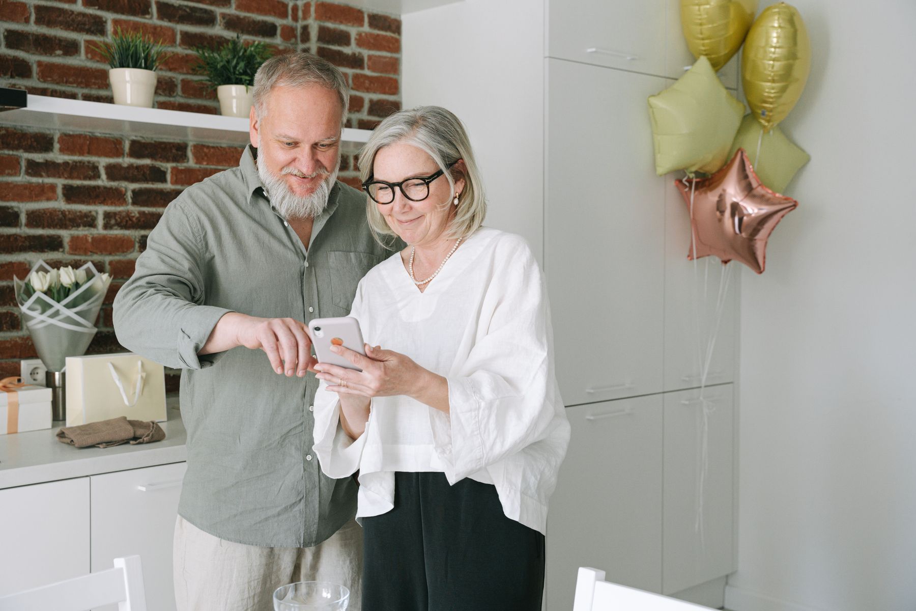 Couple checking their savings progress on a phone budgeting app