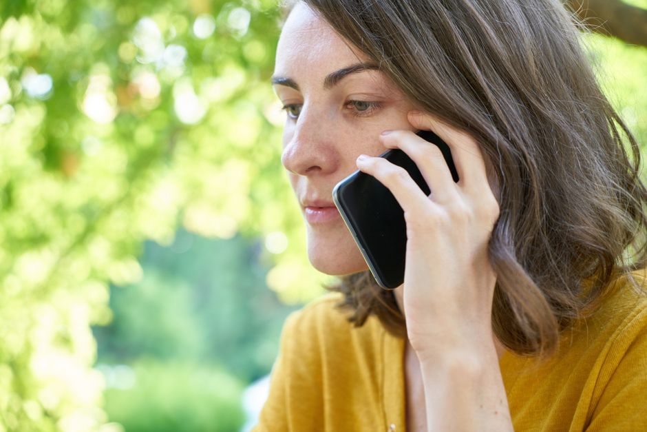 Checking AARP discount offers on a smartphone before buying tickets