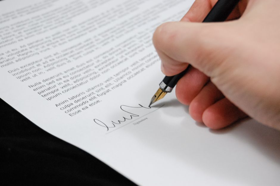 printed congressional bill document with a pen on top