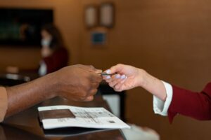 Retired traveler showing a membership card at a hotel check-in desk