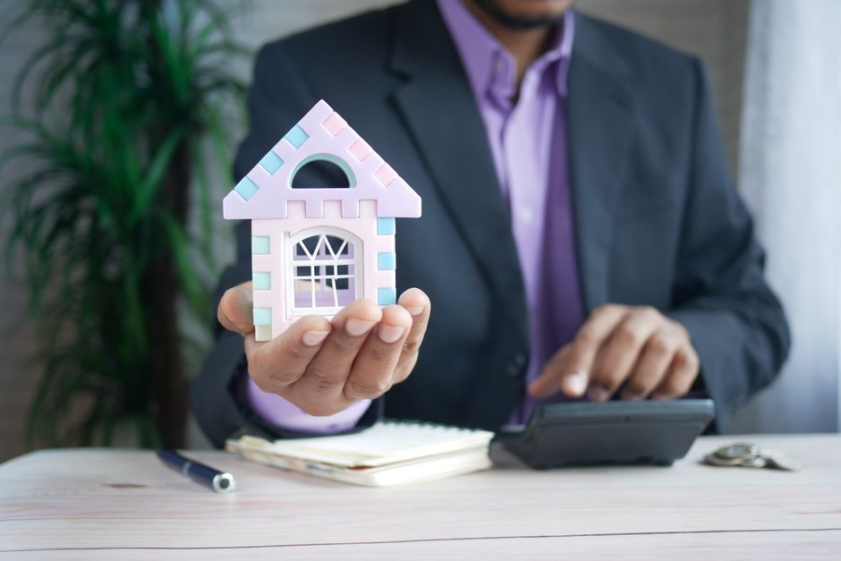 Small house model next to a calculator representing property tax deduction calculations
