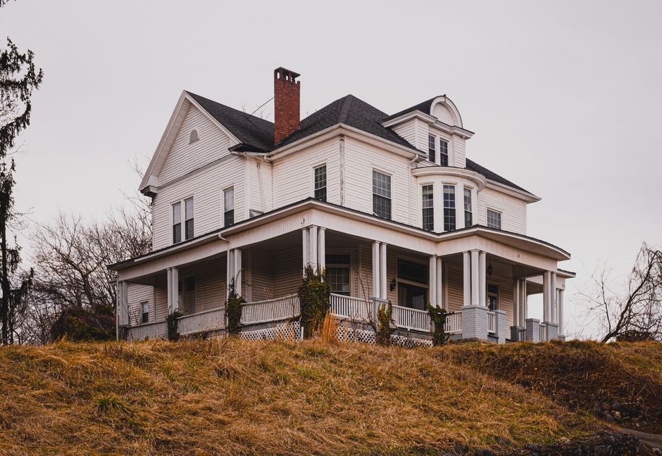 Missouri homeowner walking up to the front porch of a single-family home in autumn