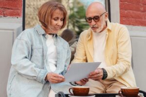 Senior North Carolina homeowners reviewing a property tax bill at their front porch