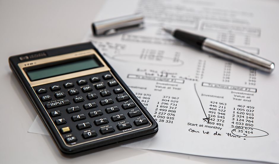 Calculator and monthly budget sheet on a desk