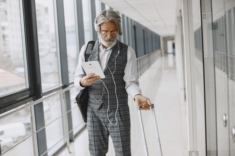 senior traveler checking airline senior discount fares 2026