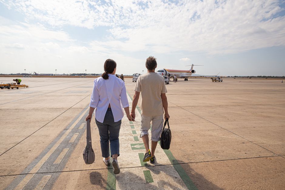 senior travelers boarding flight with discounted airfare 2026