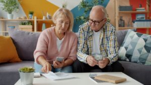 Retired couple reviewing property tax and income tax documents at the kitchen table