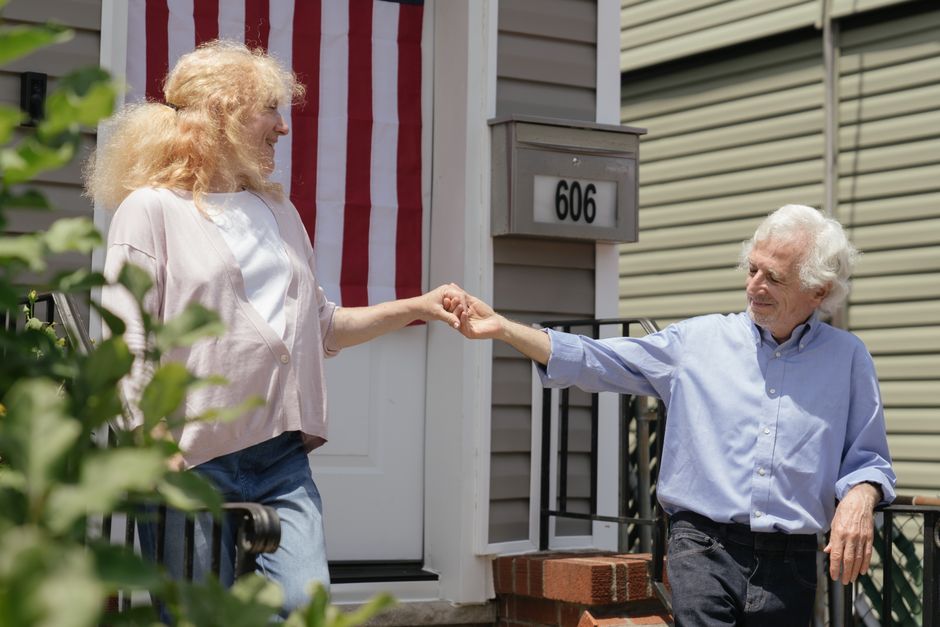 Senior couple standing in front of their Tennessee home