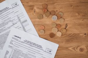 Senior woman reviewing federal tax forms at a kitchen table