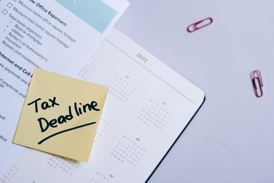 Calendar with a deadline circled next to tax envelopes