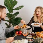 Couple enjoying a small Thanksgiving dinner at a set table
