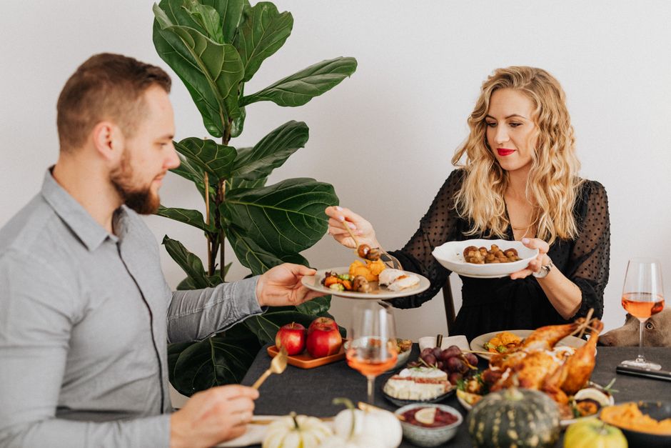 Couple enjoying a small Thanksgiving dinner at a set table